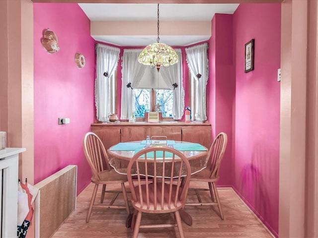 dining room featuring an inviting chandelier and light wood-type flooring