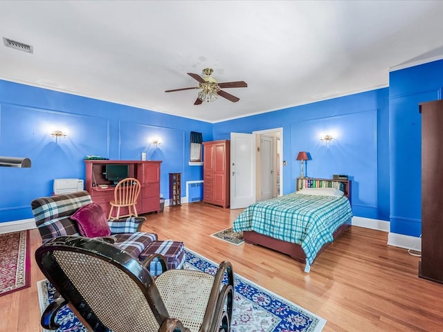 bedroom with hardwood / wood-style floors and ceiling fan