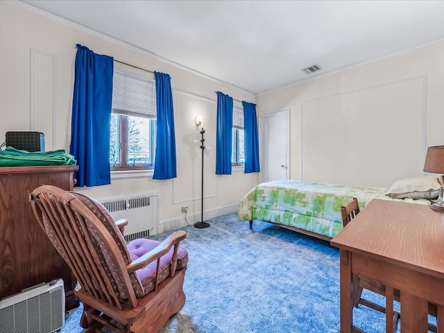 carpeted bedroom with radiator heating unit