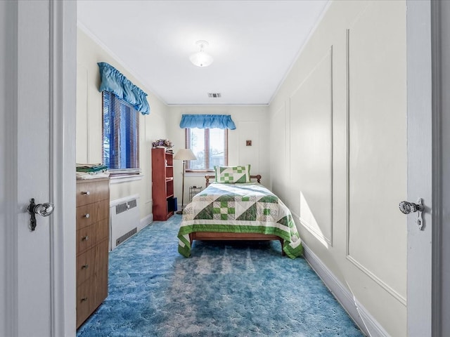 bedroom featuring crown molding, radiator heating unit, and dark carpet