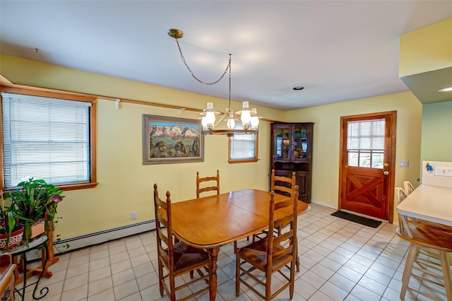 tiled dining space featuring a baseboard heating unit and an inviting chandelier