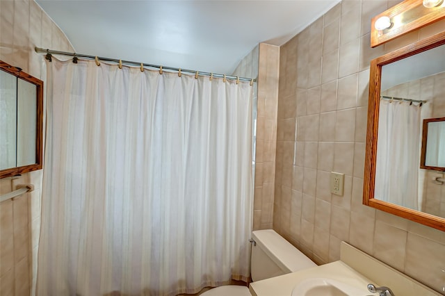 bathroom featuring sink, toilet, walk in shower, and tile walls