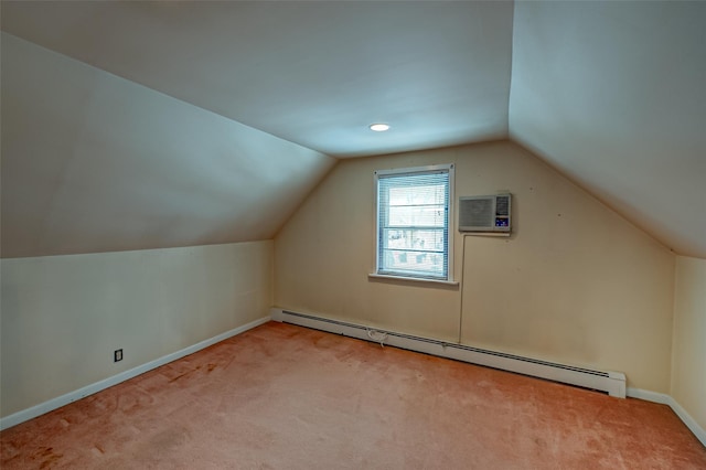 additional living space featuring light carpet, a wall unit AC, vaulted ceiling, and a baseboard heating unit