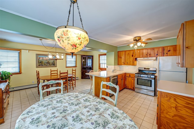 kitchen featuring under cabinet range hood, light tile patterned floors, a peninsula, stainless steel appliances, and a baseboard radiator