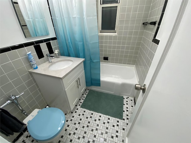 full bathroom featuring tile walls, vanity, toilet, and shower / bath combo with shower curtain