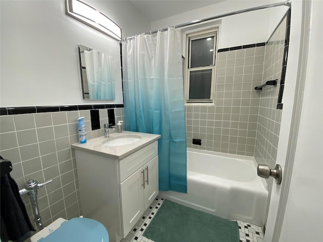 full bathroom with tile patterned floors, toilet, tile walls, vanity, and shower / bath combo