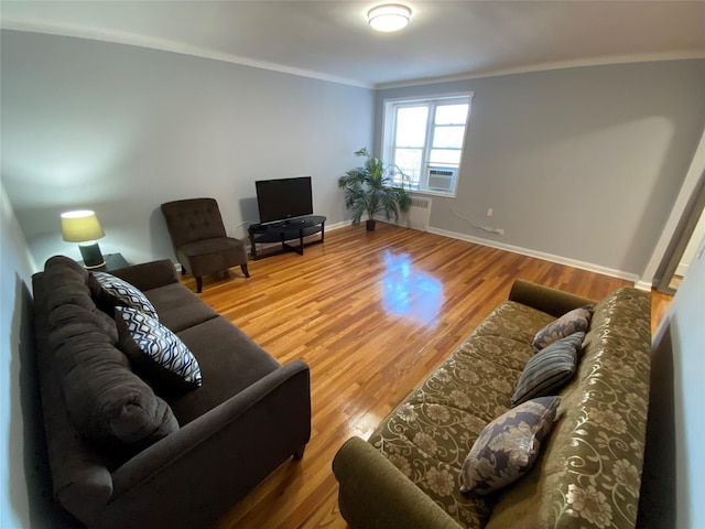 living room featuring crown molding, radiator, hardwood / wood-style floors, and cooling unit