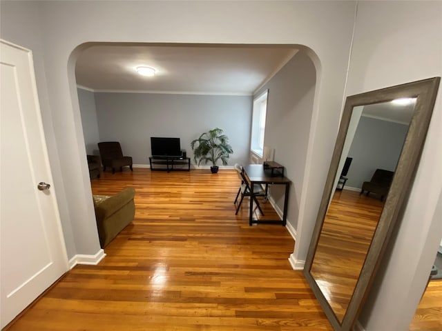 corridor featuring hardwood / wood-style flooring and crown molding