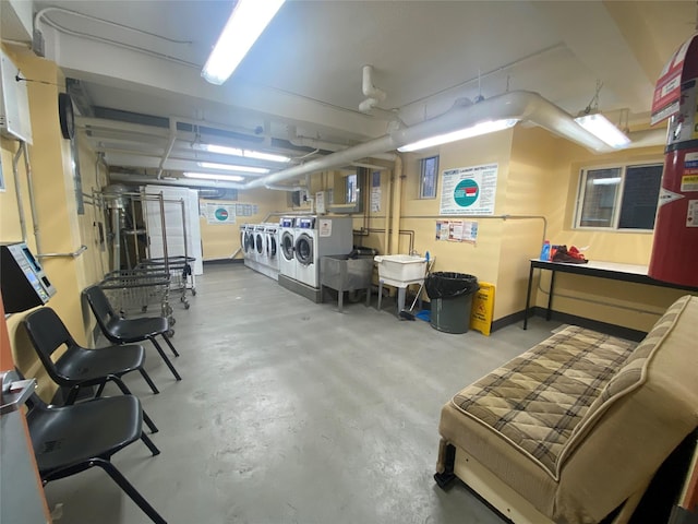 basement featuring separate washer and dryer and sink