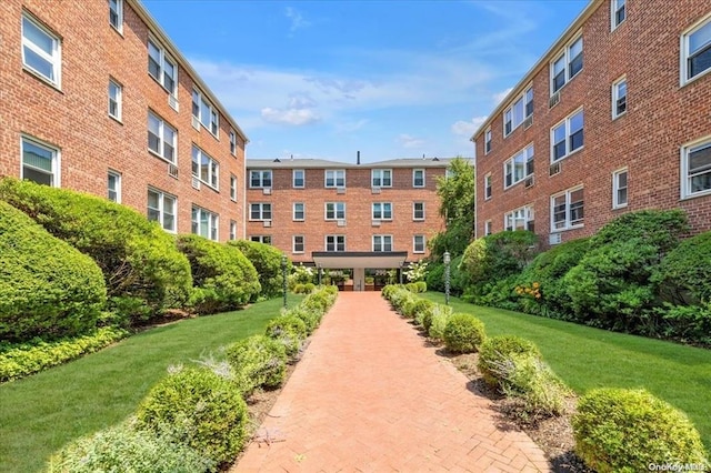 view of property's community featuring a yard