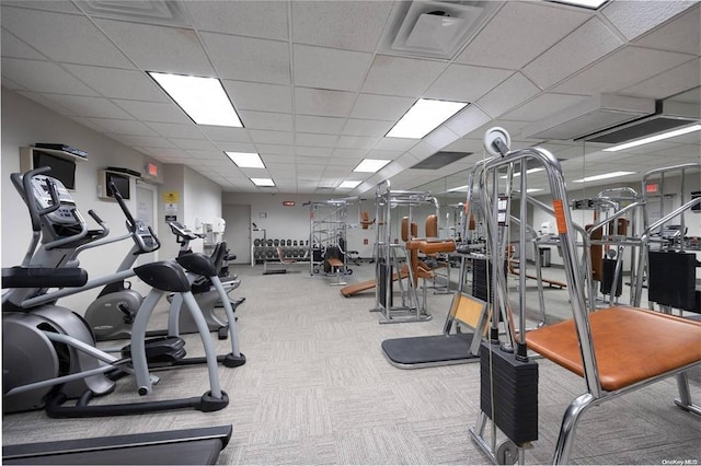 gym with light colored carpet and a paneled ceiling