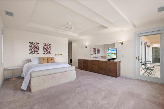 bedroom featuring access to outside, light carpet, ceiling fan, and a tray ceiling