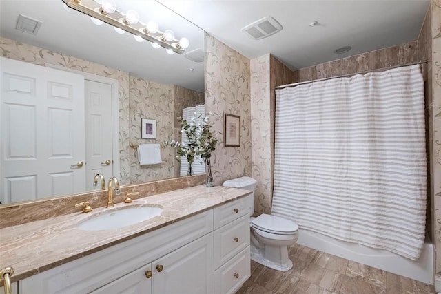 full bathroom with shower / bathtub combination with curtain, vanity, and toilet