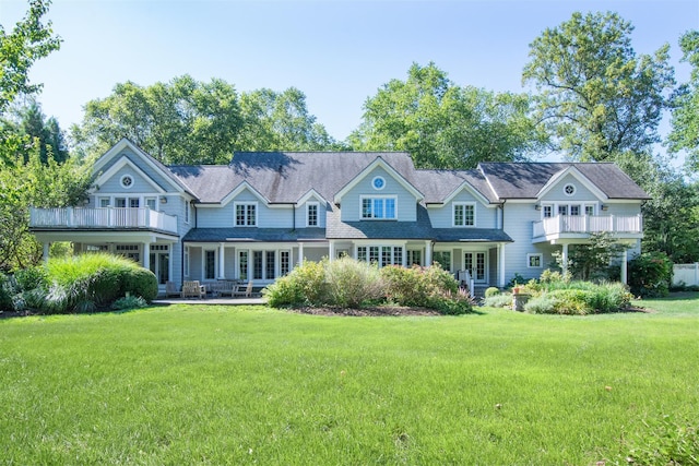 rear view of house with a yard and a patio area