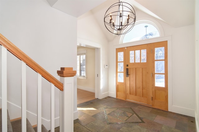 entryway featuring a chandelier and vaulted ceiling