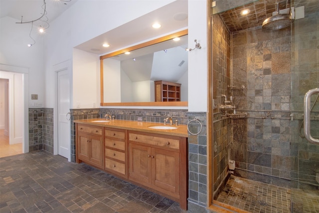 bathroom featuring walk in shower, vaulted ceiling, tile walls, vanity, and decorative backsplash