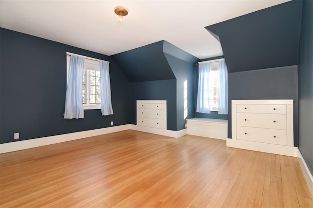 bonus room featuring lofted ceiling and light hardwood / wood-style floors