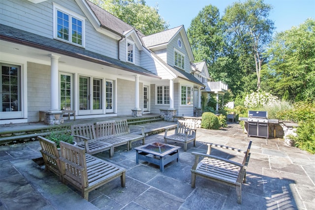 view of patio / terrace featuring area for grilling and an outdoor living space with a fire pit