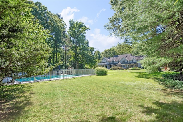 view of yard with a fenced in pool