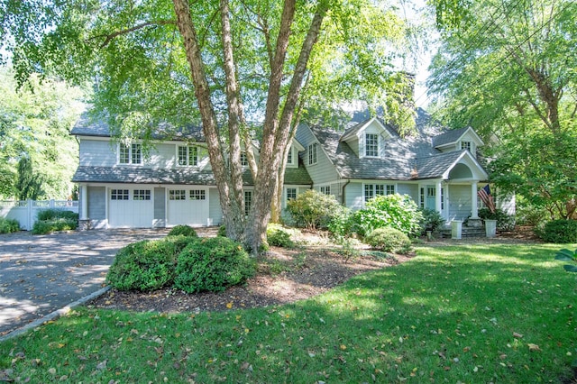 view of front of house with a garage and a front yard