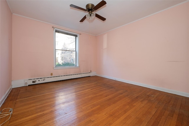 empty room featuring a baseboard radiator, wood-type flooring, ceiling fan, and crown molding