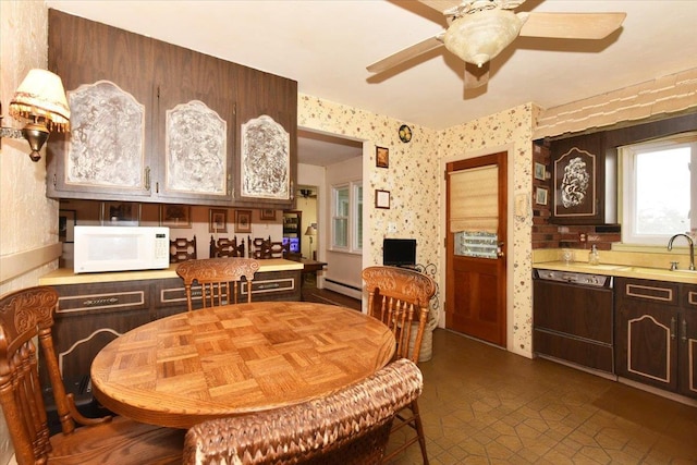 dining space featuring sink, a baseboard radiator, and ceiling fan