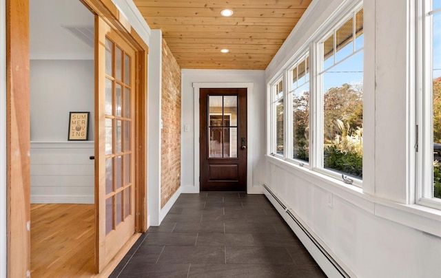 doorway with a baseboard radiator, brick wall, and wood ceiling