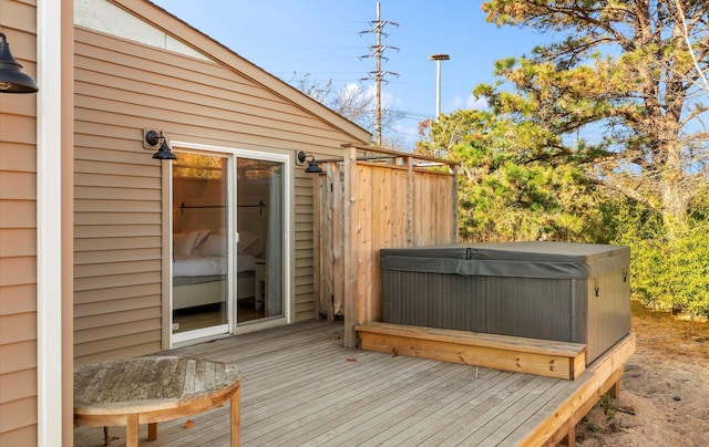 wooden deck featuring a hot tub