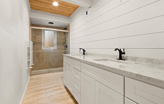 bathroom featuring wood-type flooring, an enclosed shower, wood ceiling, vanity, and wood walls