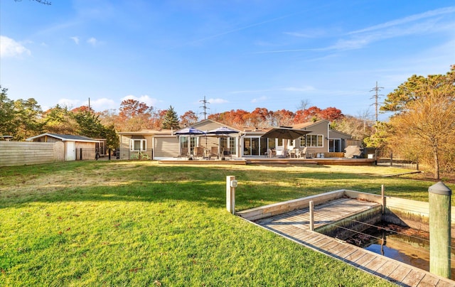 rear view of property featuring a gazebo and a yard