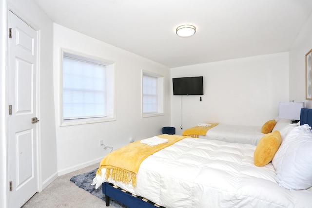 bedroom featuring light colored carpet