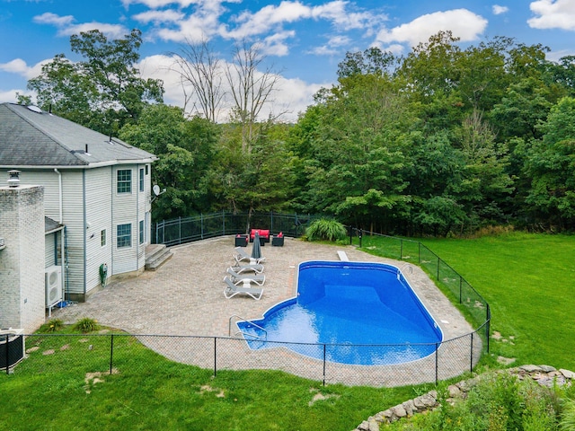 view of pool with a yard, a diving board, a patio area, and central air condition unit