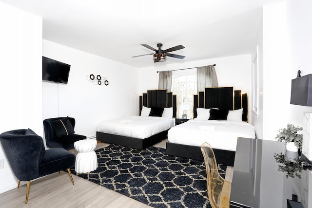 living room featuring hardwood / wood-style floors and ceiling fan