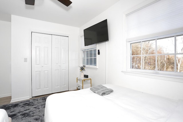 bedroom with ceiling fan and a closet