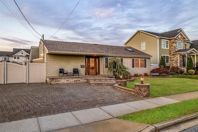 view of front of property with a patio and a front lawn