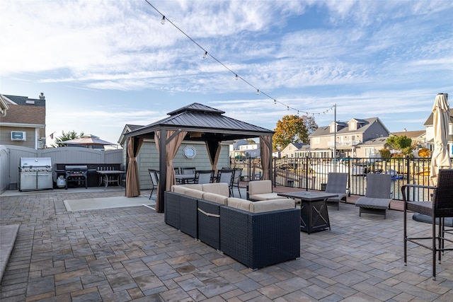 view of patio / terrace with a gazebo, grilling area, and an outdoor living space with a fire pit