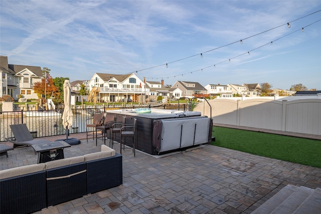 view of patio / terrace featuring an outdoor living space and a hot tub