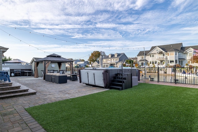 view of yard featuring a patio, a gazebo, and a hot tub