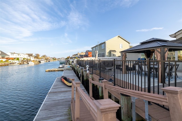 dock area with a gazebo and a water view