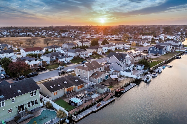 aerial view at dusk with a water view