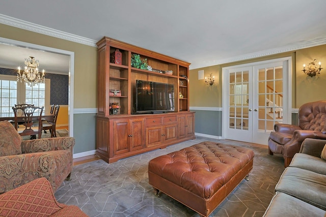 living room with an inviting chandelier, crown molding, and french doors