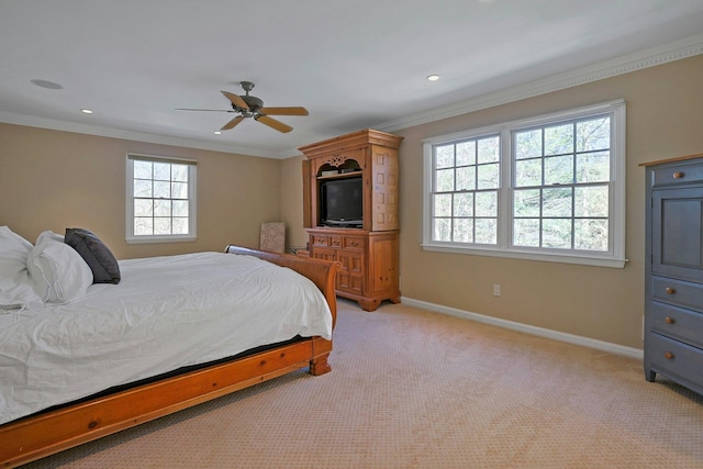 carpeted bedroom with ornamental molding and ceiling fan