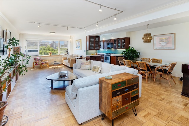 living room with ornamental molding and light parquet floors