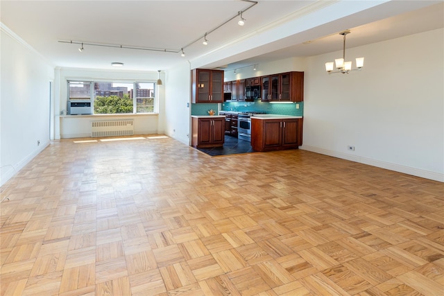 kitchen with pendant lighting, radiator, stainless steel stove, an inviting chandelier, and light parquet flooring