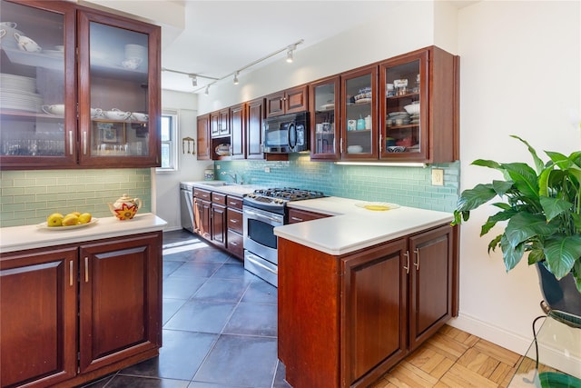 kitchen featuring appliances with stainless steel finishes, sink, and decorative backsplash