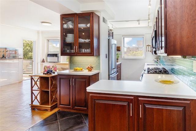 kitchen with high end fridge, backsplash, and stove