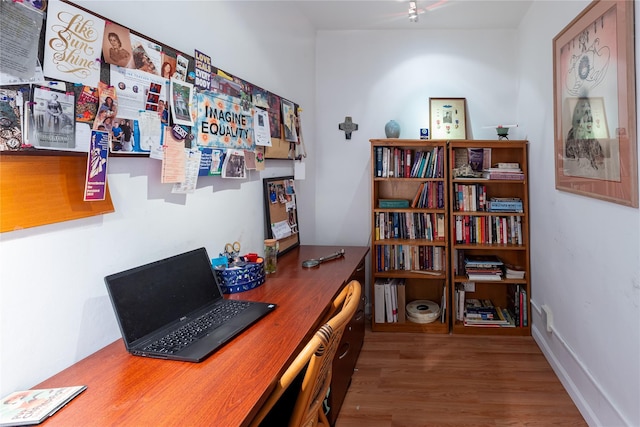 home office with hardwood / wood-style floors