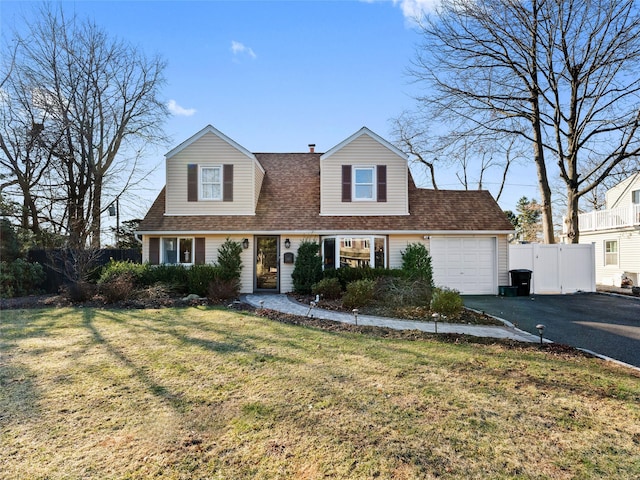 cape cod-style house with a garage and a front yard