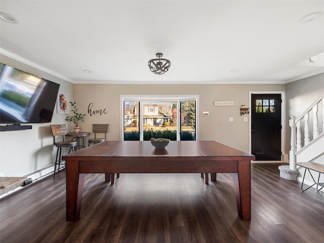 recreation room with crown molding, baseboard heating, and dark hardwood / wood-style flooring