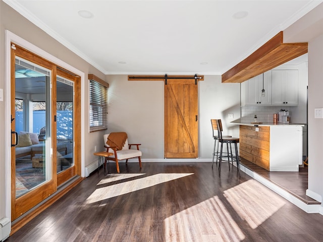 living area featuring ornamental molding, dark hardwood / wood-style floors, and a barn door